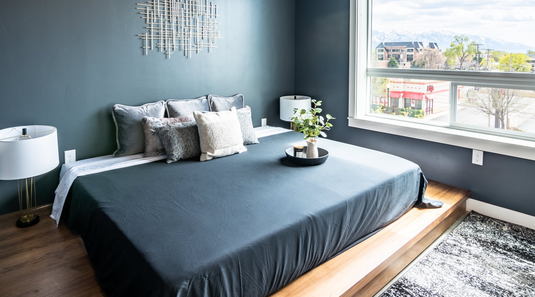 Spacious bedrooms Bedroom with lamps and a large window