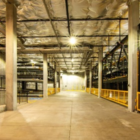 a large parking garage with a large metal railing